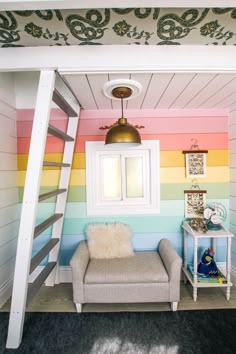 there is a loft bed with a chair underneath it and a ladder to the ceiling