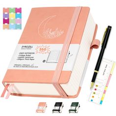 a pink notebook with pen and ruler next to it