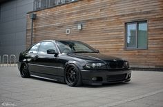 a black car parked in front of a building