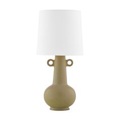 a lamp that is on top of a white tablecloth with a light shade over it