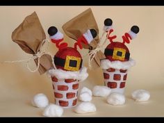 some paper cups with santa clause hats on them and candy bags in the shape of santa's chimneys