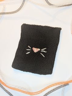 This kids hat was made with black baby yarn so it is incredibly soft! A pink nose was crocheted and sewed on the front along with 6 white whiskers. It is 6.5 inches wide and 8 inches tall. There is moderate stretch allowance to fit many sizes. Any questions please ask! Cute Black Crochet Hat For Winter, Black Crochet Yarn Beanie, Black One Size Crochet Knit Hat, Black Cat Ears Hat With Cat Design, Black Cat Design Hat With Cat Ears, Black Hat With Cat Ears And Cat Design, Cute Black Beanie (one Size Fits Most), Cute Black Beanie (one Size), Black Hand Knitted Beanie One Size