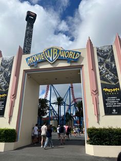 people are walking through an entrance to the movie world attraction at universal studios in hollywood, california