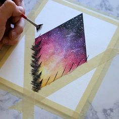 someone is painting an image with watercolors on paper