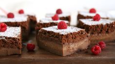 several pieces of chocolate cake with raspberries on top