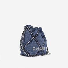 Carefully crafted from quilted stitched blue denim fabric, Chanel presents their 22 Mini. The chicest item for the lady that wants to carry everything around with them, this bag features Chanels classic interwoven back straps along with top handles to carry it handheld. This piece from 2023 is a well worthy addition to any luxury handbag collection. SPL Exterior Quilted Stitched blue denim fabric Silver hardware Chanel front hardware logo Interwoven chain and leather crossbody strap Plaque series - 2023 Immaculate condition - minor signs of use Interior Navy quilted fabric interior Slip inner pocket Chanel embossed leather logo Immaculate condition - minor signs of use Sold with dust bag SPL Height 19cm Width 20cm Depth 6cm Chanel Denim, Navy Quilt, Handbag Collection, Chanel Spring, Mini Handbag, Jeans Bag, Mini Handbags, Timeless Handbag, The Lady