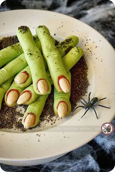 a white plate topped with green veggies next to a spider