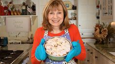 a woman in blue gloves is holding a dish