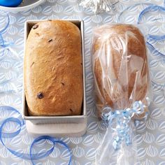 two loafs of bread sitting next to each other on top of a blue and white table cloth