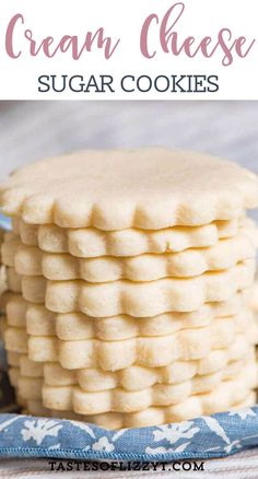 a stack of cream cheese sugar cookies sitting on top of a blue and white cloth