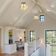 an open concept home office with white walls and wood flooring, built into the ceiling