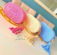 three crocheted purses sitting on top of a table