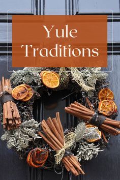 a wreath with cinnamons, orange slices and spices on it that says yule traditions