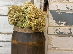 a wooden barrel with some flowers in it