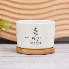 a personalized ceramic tealight holder with a wooden stand