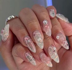 a woman's hand with some white and pink nails