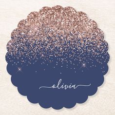 a blue and gold glitter coaster with the word alvia written in white on it