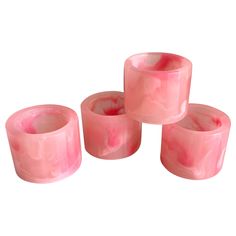 three pink candles sitting on top of each other