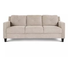 a beige couch sitting on top of a white floor