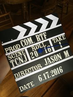 a black and white movie clapper with the words prom com rtf on it