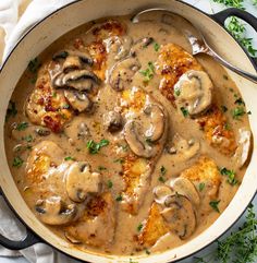 a pan filled with chicken and mushrooms covered in gravy