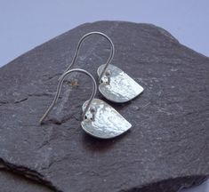 "Simple yet stylish sterling silver dangle earrings featuring a beautiful hand hammered heart. They will add a lovely touch to any outfit and will make an ideal birthday or anniversary gift. Total length: approximately 2.5 cm (0.9\") Heart: 1.5 cm (0.5\") x 1.3 cm (0.5\") The earrings will come in a beautiful gift box. * CHECK OUT MORE JEWELLERY * www.etsy.com/shop/kailajewellery" Handmade Sterling Silver Heart Earrings For Mother's Day, Handmade Dainty Sterling Silver Heart Earrings, Handmade Silver Heart Drop Earrings, Handmade Sterling Silver Heart Pendant Earrings, Handmade Silver Teardrop Heart Earrings, Handmade Sterling Silver Teardrop Heart Earrings, Handmade Teardrop Heart Earrings In Sterling Silver, Handmade Teardrop Sterling Silver Heart Earrings, Heart Earrings Silver