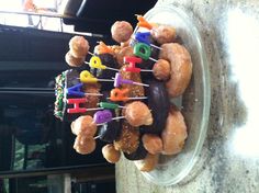 a birthday cake with donuts and candles in the shape of happy birthdays on top