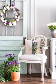 a white chair sitting next to a potted plant