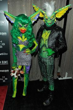 two people dressed in costumes standing next to each other