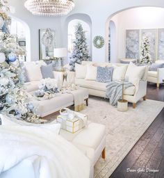 a living room decorated for christmas with white furniture