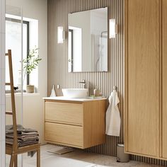 a bathroom with a sink, mirror and towel rack