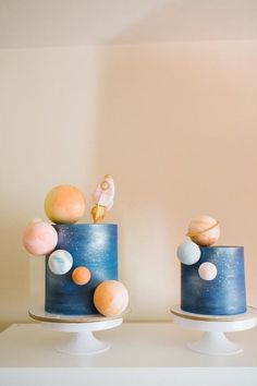 two cakes decorated with planets on top of each other