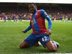 a man sitting on top of a soccer field