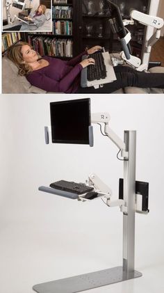 there is a woman laying on the floor using a computer and sitting at a desk