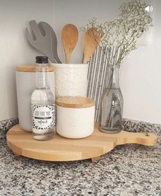 kitchen utensils are sitting on a wooden tray