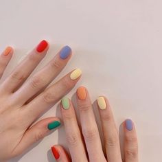 two hands with different colored manies on them