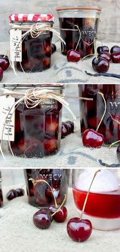 jars filled with cherries sitting on top of a table