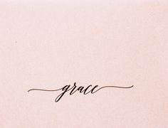 the word grace written in cursive writing on a piece of pink paper with black ink