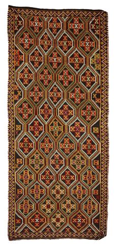 an antique afghan rug with geometric design