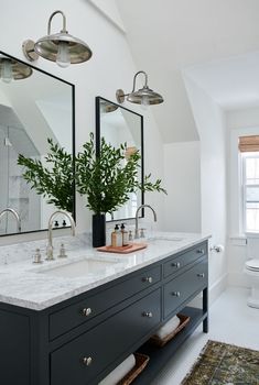 a bathroom with two sinks and mirrors in it