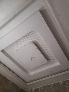 the ceiling in this room is white and has a square shaped pattern on it's surface