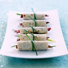 small appetizers are arranged on a white plate