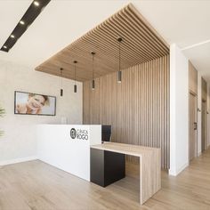 an office with wood paneling and a white reception desk in front of a wooden wall