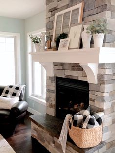 a living room filled with furniture and a fire place in front of a stone fireplace