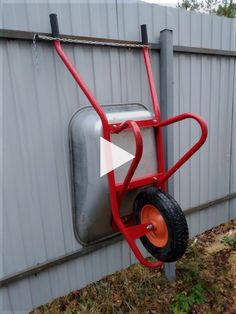 a wheelbarrow attached to the side of a building