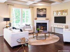 a living room filled with furniture and a flat screen tv mounted on the wall above a fireplace