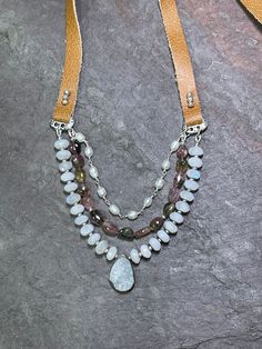 Like a picnic in the park!  The layered look, made simpler.   Layered necklaces are still very much in style and I always appreciate mixing stones, colors, textures...but hate having all those clasps at the back of my neck.  Problem solved!    Lovely smooth, AAA Tourmaline in all sorts of pretty colors, beautiful Moonstones accented with a white druzy pendant, and a strand of hand wrapped genuine pearls.  They meet up with soft milk light brown leather, and a sterling silver bead slides to let you adjust the length from approximately 16" - 26". Thanks so much for stopping by today, and for supporting small, artisan, and handcrafted goods businesses - it matters. 💛 Everyday Bohemian Crystal Necklaces With Gemstone Beads, Bohemian Crystal Gemstone Necklaces For Everyday, Bohemian Crystal Necklaces With Gemstone For Everyday, Bohemian Crystal Necklace With Gemstone For Everyday, Bohemian Gemstone Crystal Necklaces For Layering, Bohemian Necklaces With Natural Stones For Everyday, Bohemian Gemstone Crystal Necklace For Layering, Handmade Adjustable Crystal Necklaces For Layering, Handmade Adjustable Crystal Necklace For Layering