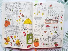 an open notebook with doodles and writing on the pages is shown in front of leaves