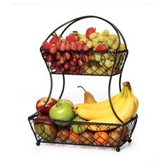 two tiered metal fruit basket with apples, bananas, and strawberries on top