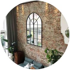 a living room filled with furniture and a large window in the middle of it's wall